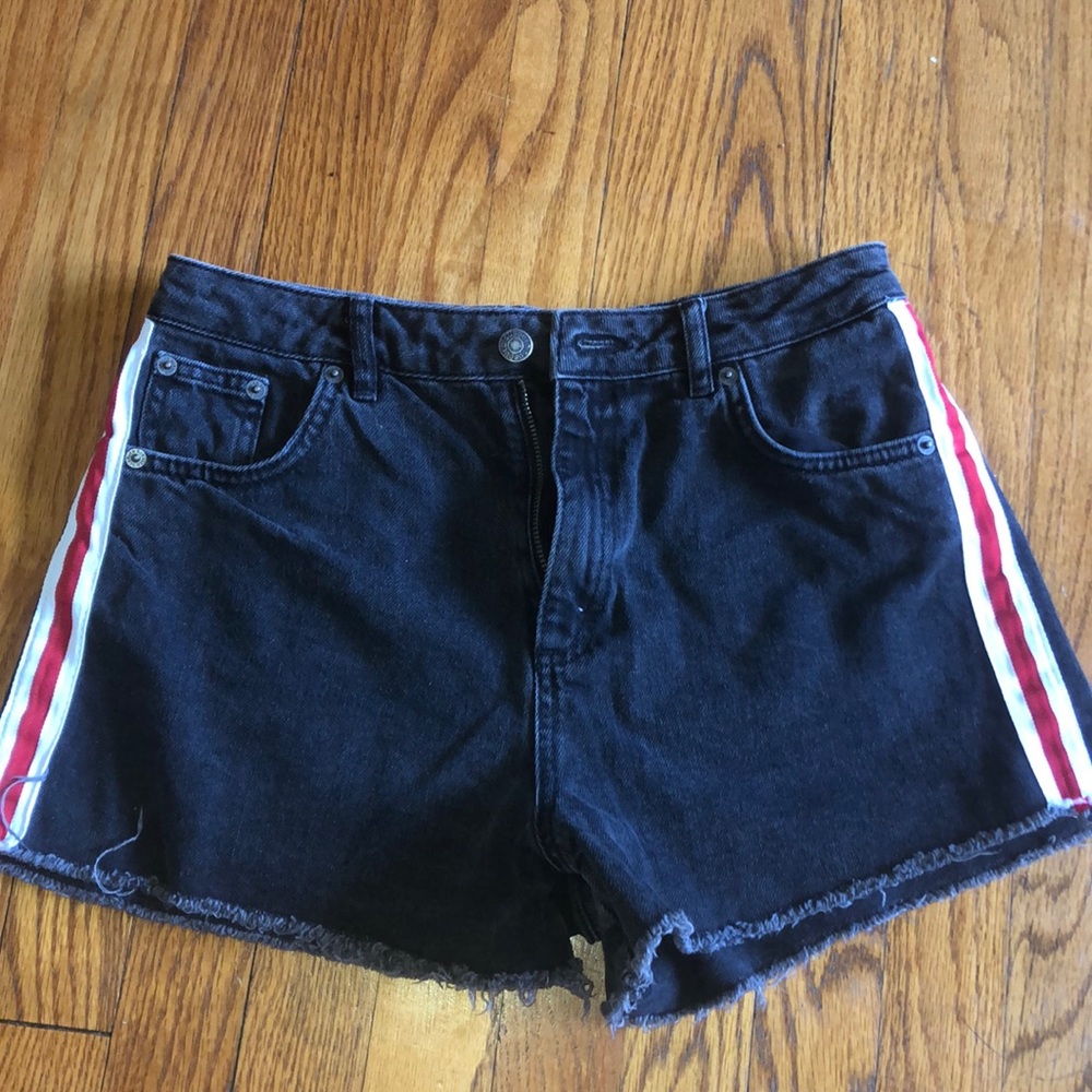 Black denim shorts with red and white stripe